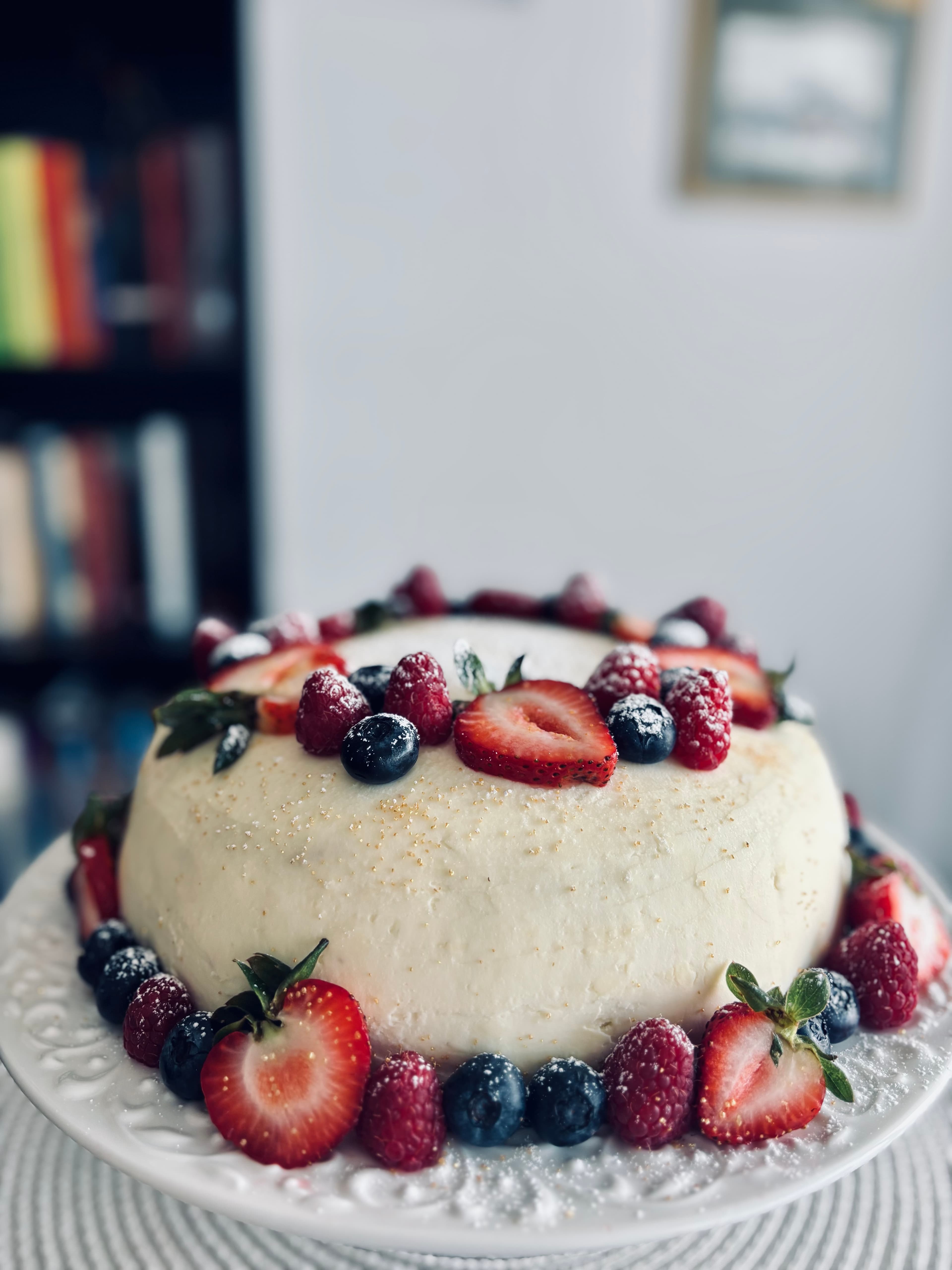 Berry cake decorated with cream and fresh berries