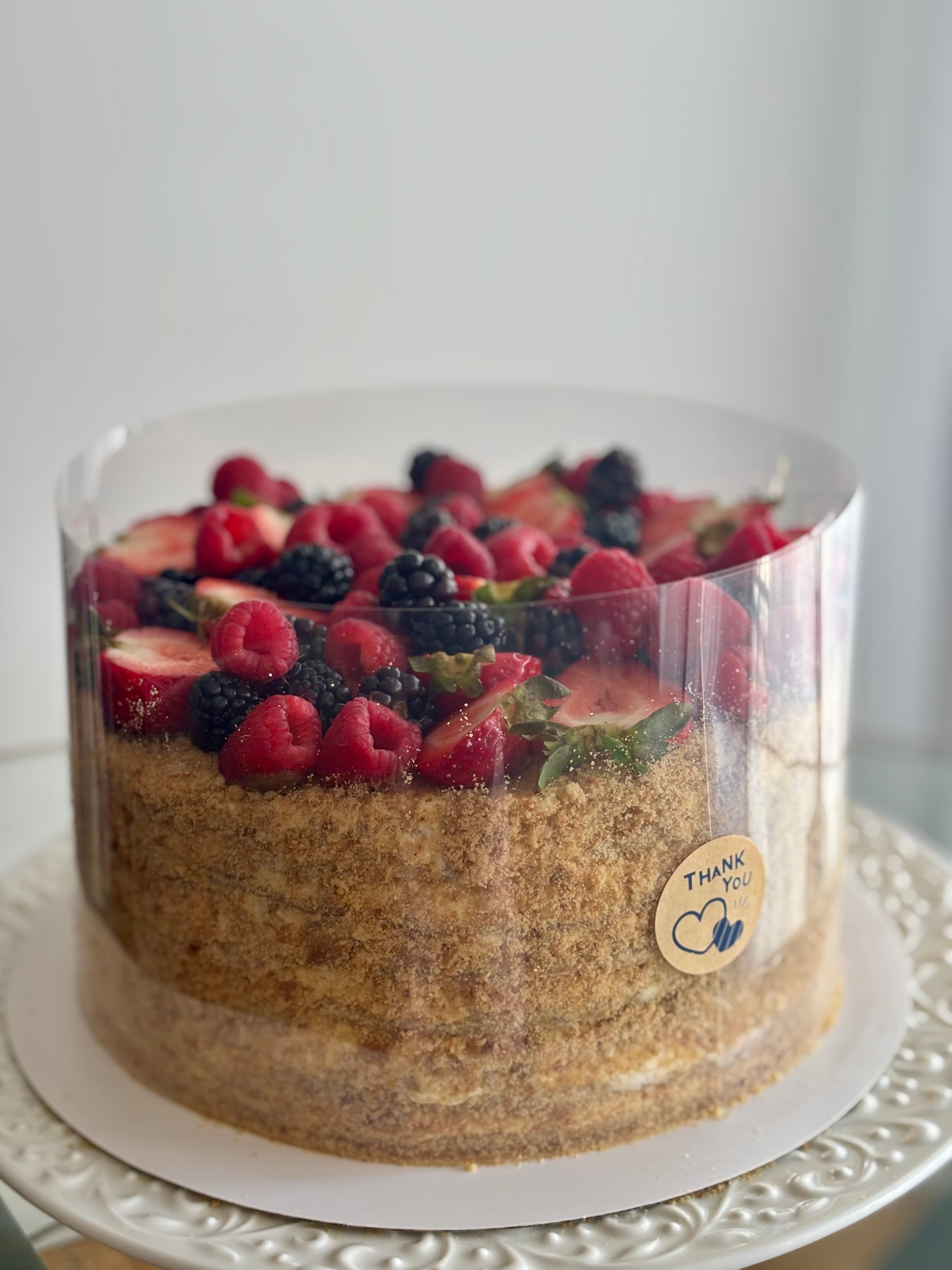 Layered medovik cake with cream and crumb coating